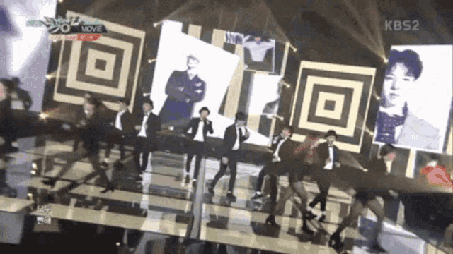 a group of people are dancing on a stage with a kbs2 logo in the corner