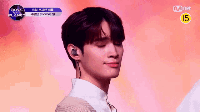a close up of a person wearing earphones with a mnet logo in the corner