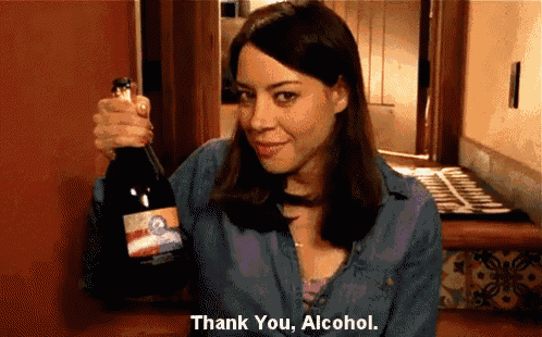 a woman holds a bottle of wine and says " thank you alcohol "
