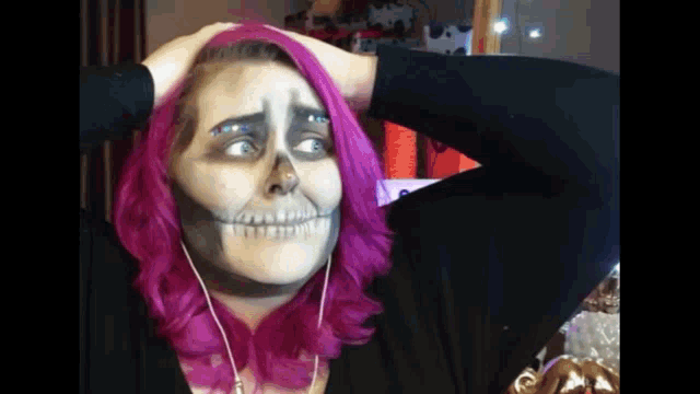 a woman with pink hair has a skeleton makeup on her face