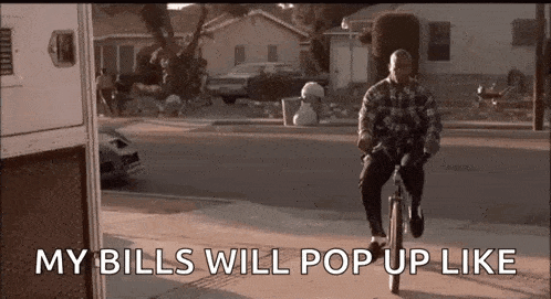 a man is riding a bike down a street with the words `` my bills will pop up like '' written on the screen .