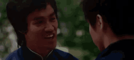 two men are talking to each other and one of them is pointing at the other 's face .