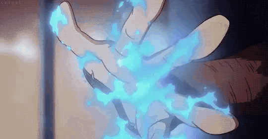a person is holding a blue flame in their hand .