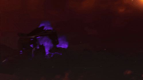 a purple light is shining on a dark background