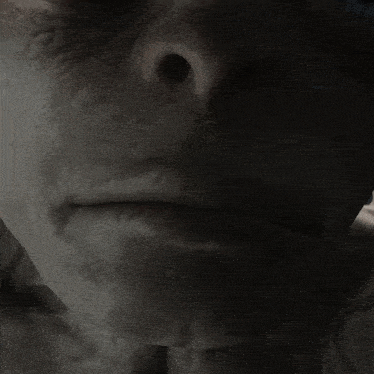 a close up of a person 's face with a large blue eye