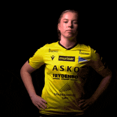 a girl wearing a yellow shirt that says asiko frydenbo