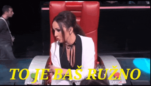 a woman is sitting in a chair with the words to je bas ruzno written on the bottom