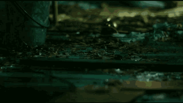 a bucket is sitting on the ground next to a spoon