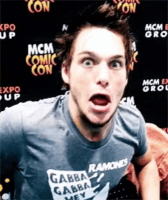 a man wearing a garba ramones t-shirt is making a funny face