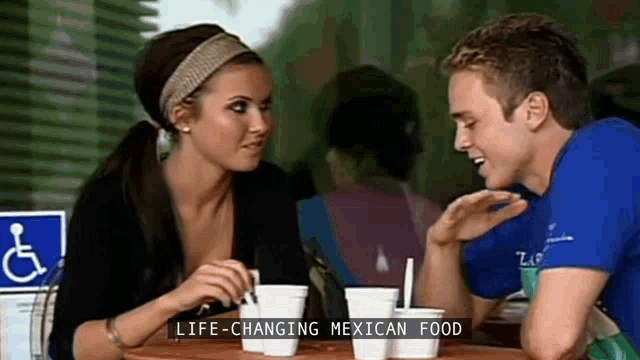 a man and a woman are sitting at a table with the words life-changing mexican food on the bottom
