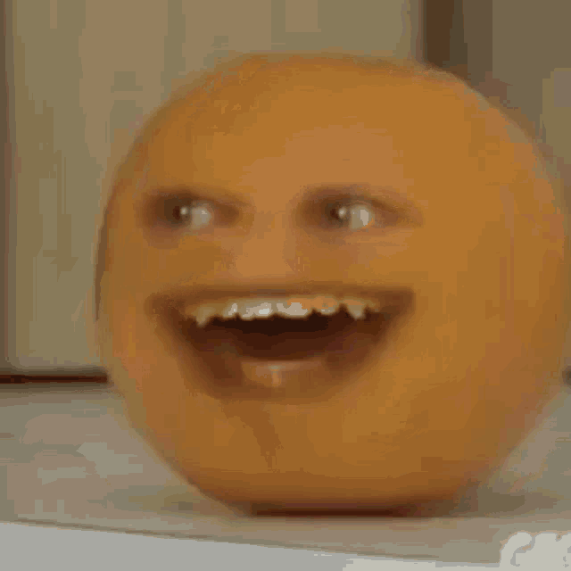 a red apple with a face on it is sitting on a table next to a jar .