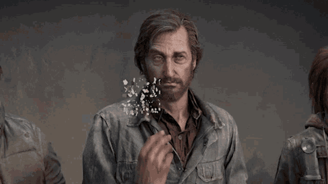 a man with a beard is surrounded by confetti coming out of his face