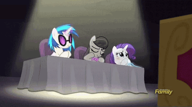 three ponies are sitting at a table in front of a sign that says " family "