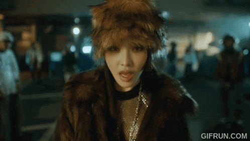 a woman wearing a fur coat and a hat with gifrun.com written on the bottom right