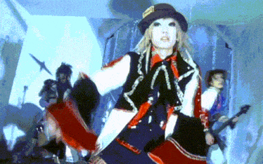 a woman wearing a top hat with the letter a on it is dancing