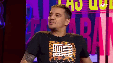 a man wearing a black shirt that says me on it
