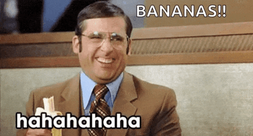 a man in a suit and tie is smiling while holding a banana and says bananas !