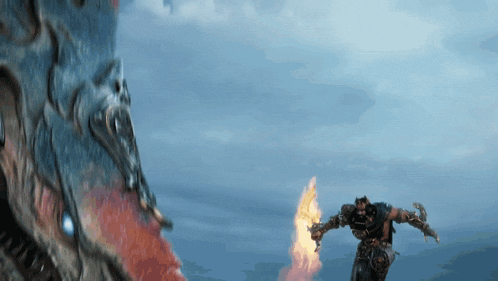 a man is holding a torch in front of a giant dragon