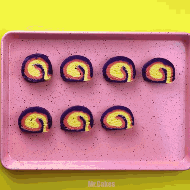 a pink tray with a yellow and purple swirl on it