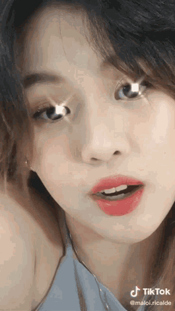 a close up of a woman 's face with a tiktok watermark on it