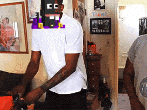 a man in a white shirt has a pixelated face with the letter cc on it