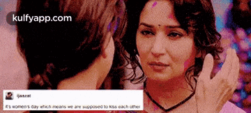 a picture of two women looking at each other with a caption that says ' it 's women 's day ' on it