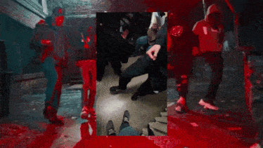 a group of people are standing in a room with blood on the ground