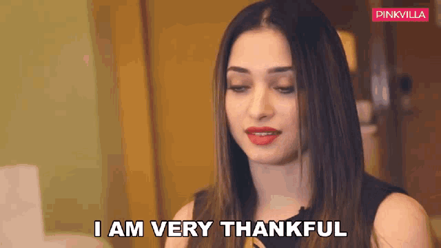a woman is saying i am very thankful in a room .