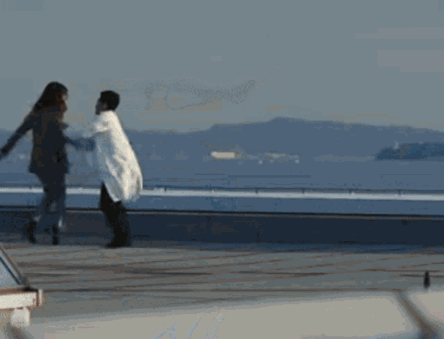 a man in a white coat is running towards a woman in a brown jacket