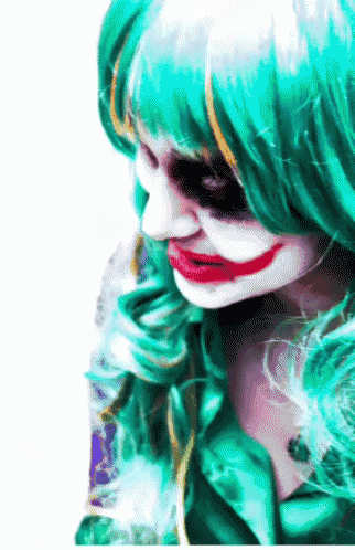 a woman in a joker costume with green hair is smiling