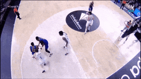 a basketball game is being played on a court that has a banco logo on the floor