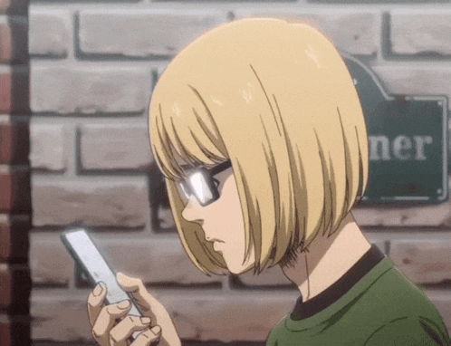 a person looking at a cell phone in front of a sign that says " ner "
