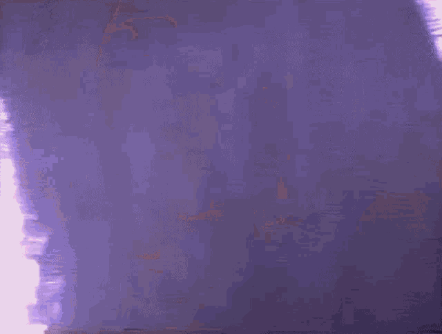 a close up of a woman 's face with a purple background and a blurred background .