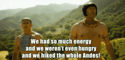 two shirtless men standing next to each other with mountains in the background