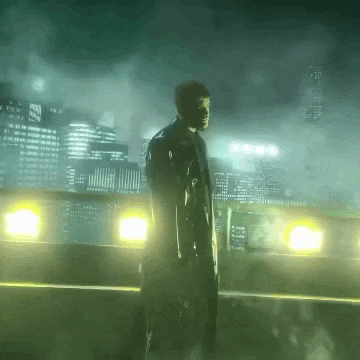a man in a trench coat stands in front of a city skyline at night