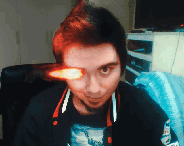 a man with a flame coming out of his eye is wearing a t-shirt that says ' new york '