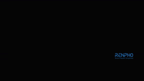 a black massage gun is sitting on a black background .