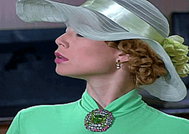 a woman wearing a white hat and a green top