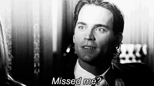 a man in a suit and tie is looking at a woman and says `` missed me ? ''