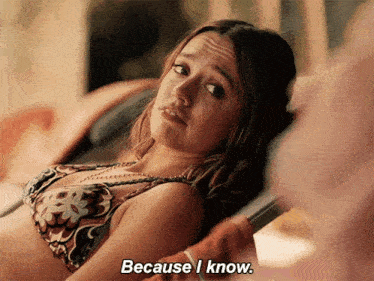a woman in a bikini is laying on a chair and says because i know