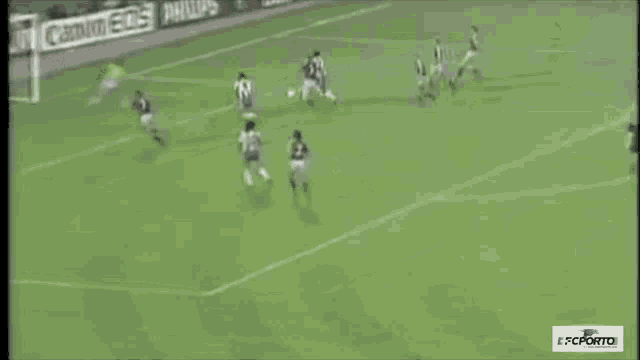 a soccer game is being played in front of a canon eos sign
