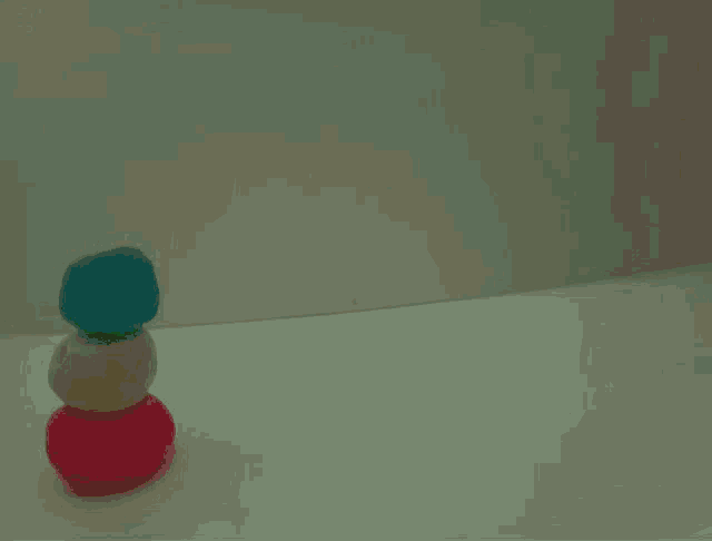 three different colored balls stacked on top of each other