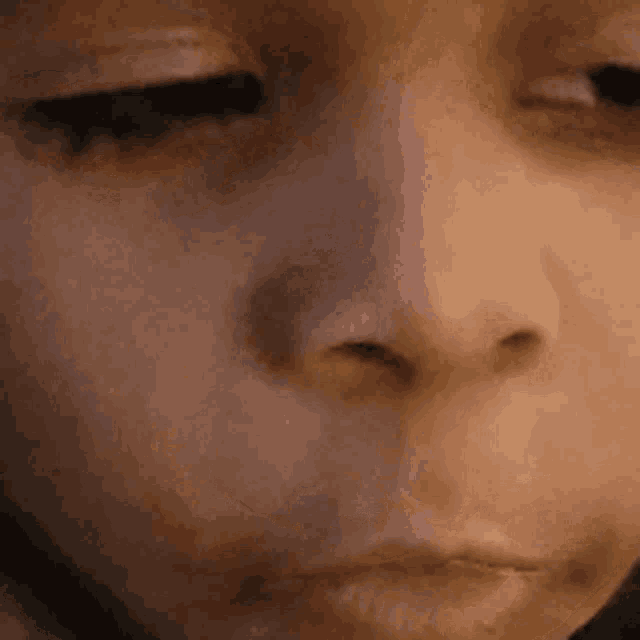 a close up of a person 's face with their eyes closed and mouth open .