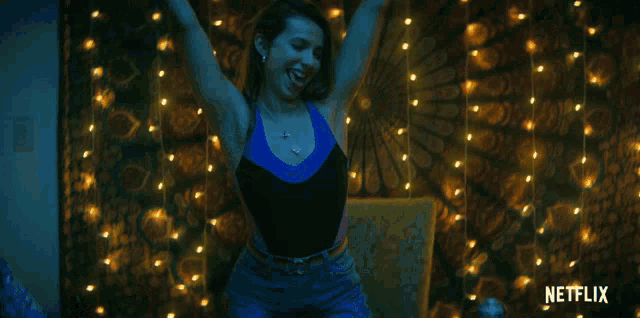 a woman dancing in front of a netflix logo