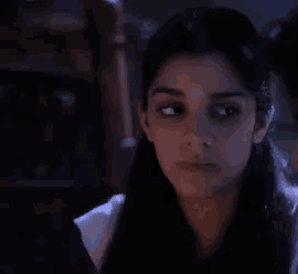 a close up of a woman 's face in the dark