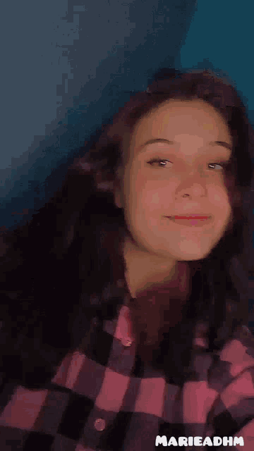 a girl in a plaid shirt is smiling and says come here * hugs *
