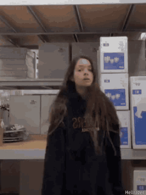 a girl wearing a black hoodie with the number 28 on the front