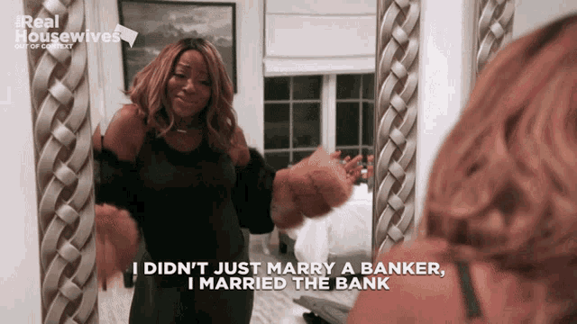 a woman is standing in front of a mirror and says i did n't just marry a banker i married