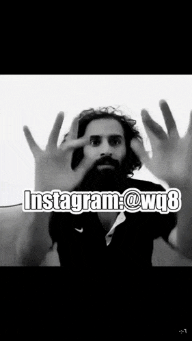 a man with a beard is making a gesture with his hands and the words instagram @ wq8 are above him