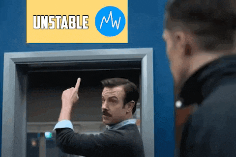 a man with a mustache is pointing his finger at another man in front of a sign that says `` unstable mw '' .